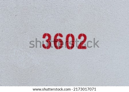 Red Number 3602 on the white wall. Spray paint.
