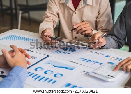 Bookkeeper accountant or financial expert, male economist accounting money with statistics graphs pointing on the accounts for investment results and income Company expenditure  Royalty-Free Stock Photo #2173023421