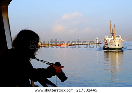 A tourist take boat's photo in istanbul
