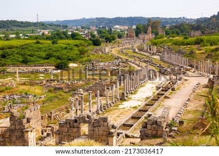 Rows of columns in Perge, Antalya, Turkey. Remains of colonnaded street in Pamphylian ancient city. Royalty-Free Stock Photo #2173036417