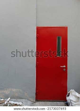 Photo of a red emergency exit door in a downtown building