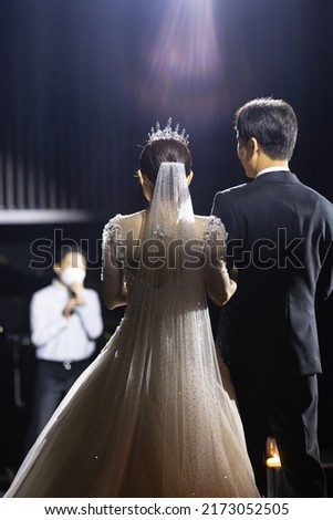 Back view of the bride and groom listening to a song in wedding day
