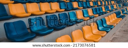 Rows of plastic seats at a stadium. Landscape picture at  stadium.