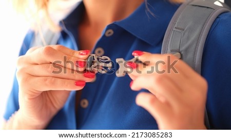 Woman fastens carabiner clasp on backpack closeup Royalty-Free Stock Photo #2173085283