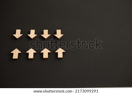 Wooden arrows point on black background. Space for your text
