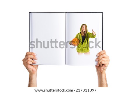 Young girl with thumb up printed on book