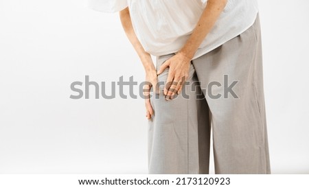 Health image of middle woman rubbing her knee