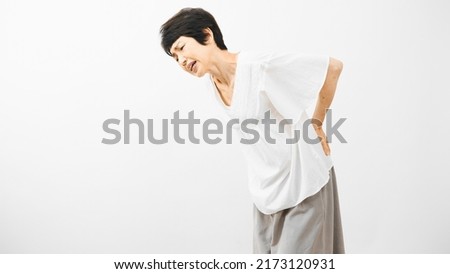 Health image of middle woman rubbing her lower back　