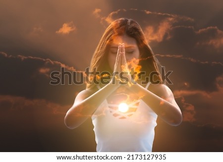 Young meditation woman feeling free on nature at sunrise. Royalty-Free Stock Photo #2173127935