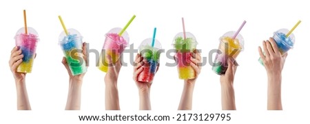 Hands of crop unrecognizable people holding plastic cups with colorful refreshing slush beverages with straws against white background in studio Royalty-Free Stock Photo #2173129795