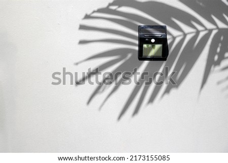 copy space of Solar-powered motion sensor light isolated on cement or concrete wall background, image