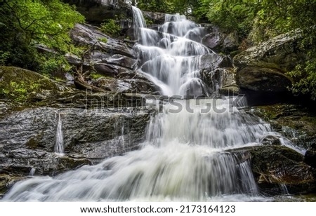 The cascade of the waterfall flows over the stones. Waterfall cascade. Waterfall in forest. Waterfall Royalty-Free Stock Photo #2173164123