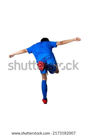 Rear view of football player man in a blue jersey with the pose of kicking the ball isolated over white background Royalty-Free Stock Photo #2173182007