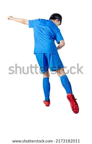Rear view of football player man in a blue jersey with the pose of kicking the ball isolated over white background Royalty-Free Stock Photo #2173182011