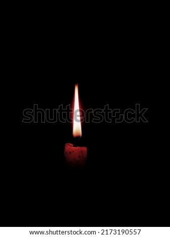 Burning candle in dark night 
