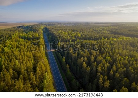 Aerial view of a road near by Ladoga lake on sunny summer morning. Surroundings of Kokkorevo village, Leningrad Oblast, Russia. Royalty-Free Stock Photo #2173196443