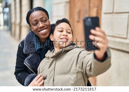 African american mother and son smiling confident make selfie by the smartphone at street
