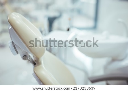 A clean modern well equipped dental surgery prepped and ready to take the first patient of the day . Horizontal color image of modern dental office with equipment.