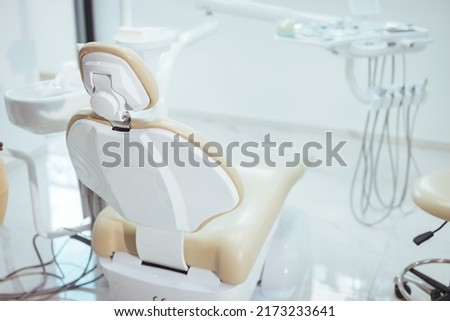 Dentistry, medicine, medical equipment and stomatology concept - interior of new modern dental clinic office with chair. Interior of the office of patients reception with dental equipment Royalty-Free Stock Photo #2173233641