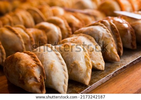 freshly baked empanadas with different fillings for Royalty-Free Stock Photo #2173242187