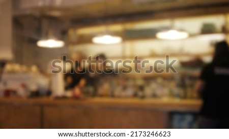 Blur Night coffee shop interior background - can used for display or montage your products.barista in counter bar Royalty-Free Stock Photo #2173246623