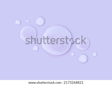 round drops of transparent gel serum on pastel background Royalty-Free Stock Photo #2173268821