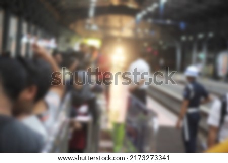 abstract blurred background crowd of prospective passengers in a train station