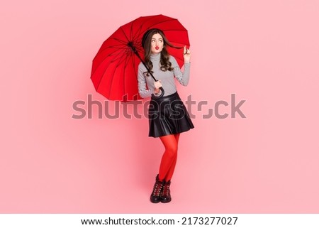Full size photo of minded cute stylish lady parisian hold parasol look rainy climate isolated pastel color background