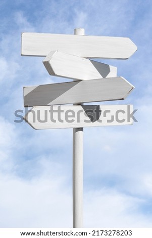 Blank white signpost on blue sky background. Choose the correct way concept. Mock up, template Royalty-Free Stock Photo #2173278203