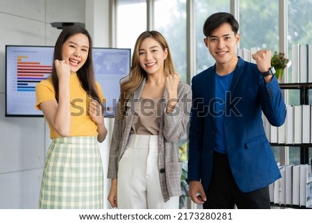 Group of Asia young entrepreneurs creative people looking at camera and excited for success project, working together in the office. Stratup business team discusses and shares ideas for new projects. Royalty-Free Stock Photo #2173280281