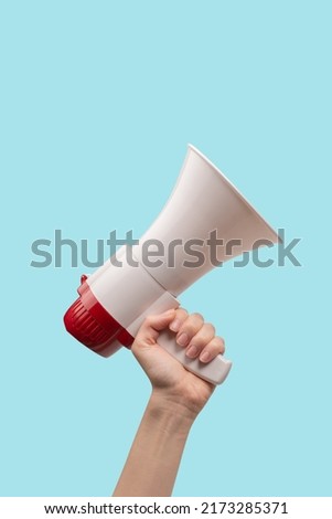 Megaphone in woman hands on a white background.  Copy space.  Royalty-Free Stock Photo #2173285371
