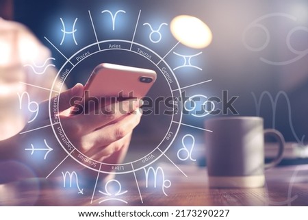 Woman with smartphone reading daily horoscope indoors, closeup