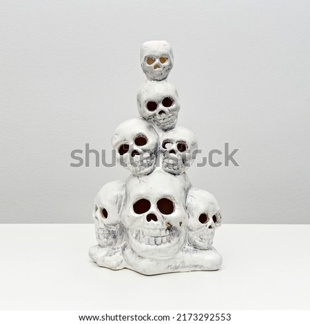 Stack of human decorative skulls for Halloween decoration on white. Celebration concept. Party decoration. Happy Halloween