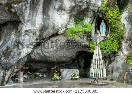 Statue of Virgin Mary in the grotto of Our Lady of Lourdes, France Royalty-Free Stock Photo #2173300885