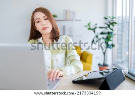 A photo of a bright Asian business woman working at home in the room. The idea is Work form Home Finance Marketing Bright Portrait Simple Break The Science Bias