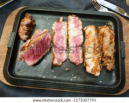 Sliced medium rare roasted beef steak