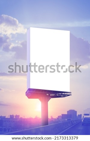 Portrait billboard advertising side is the road at sunset sky background.