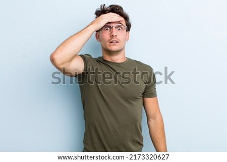 young handsome man panicking over a forgotten deadline, feeling stressed, having to cover up a mess or mistake Royalty-Free Stock Photo #2173320627