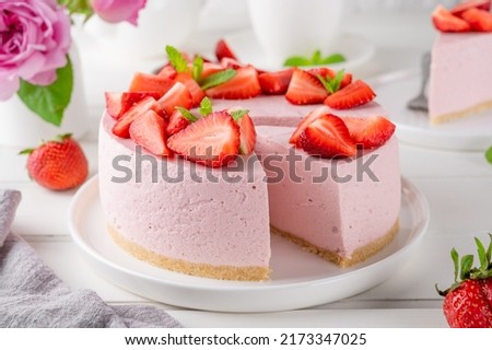 No bake cheesecake with fresh strawberries on a white wooden background. Summer dessert. Selective focus. Copy space Royalty-Free Stock Photo #2173347025