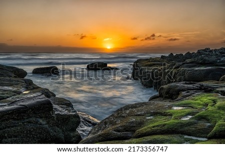 Dawn over the sea coast. Coastline at dawn. Beautiful sunrise over sea horizon. Sea horizon at dawn Royalty-Free Stock Photo #2173356747