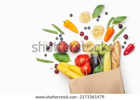 paper bag with groceries on white