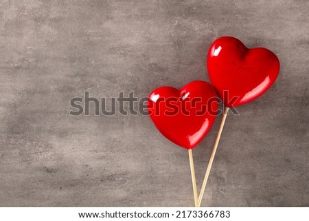 Valentines day background with two red hearts on pastel background.