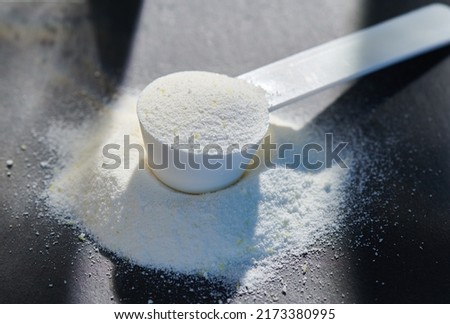 Sport food supplement powder with natural beige background and props. Supplement, creatine, hmb, bcaa, amino acid or vitamine in a white scoop. Sport nutrition concept... Check my profile for more! Royalty-Free Stock Photo #2173380995