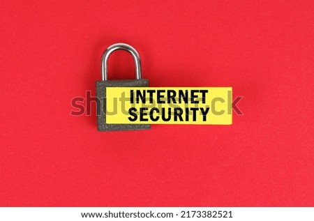 Business and security concept. On the red surface there is a lock with a sticker with the inscription - Internet security