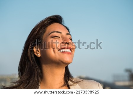 Latin woman smiles happily relaxed with her eyes closed. Copy space Royalty-Free Stock Photo #2173398925