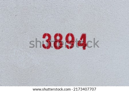 Red Number 3894 on the white wall. Spray paint.
