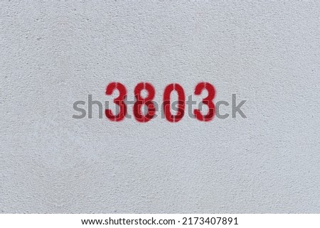 Red Number 3803 on the white wall. Spray paint.

