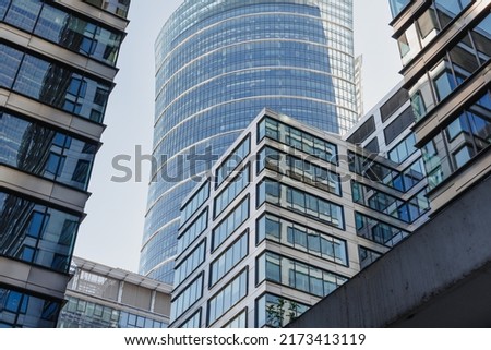 The view of the close constructed modern office buildings in the financial district. Glass towers in downtown of the city. A cluster of tall buildings. Royalty-Free Stock Photo #2173413119