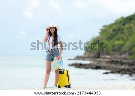 Happy traveler and tourism young women travel summer on the beach. Asian  people holding map and camera take photo  and relax outdoor for destination and leisure trip travel in holiday