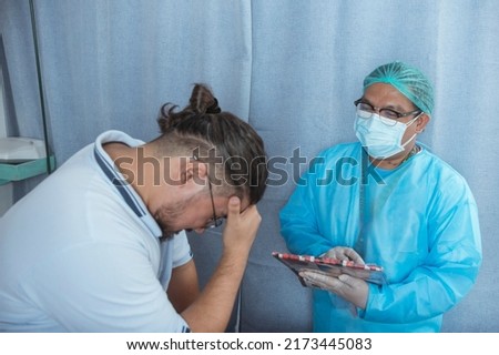 A male patient saddened by the realization of a poor and terminal diagnosis. The bad news sinking in. At the ER ward of a hospital. Royalty-Free Stock Photo #2173445083